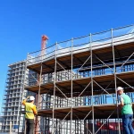 Efficient scaffolding Bolton solutions shown at an active construction site with workers assembling structures.